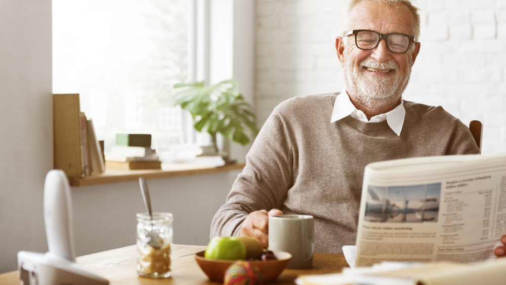 old-man-happy-reading-newspaper