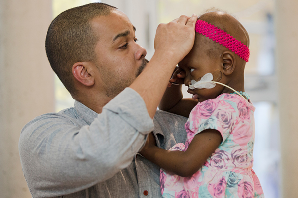 man holding child ronald mcdonald house